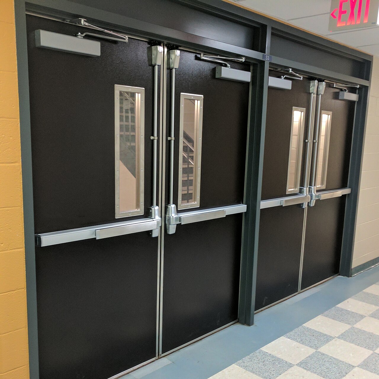 Commercial exit doors with crash bars